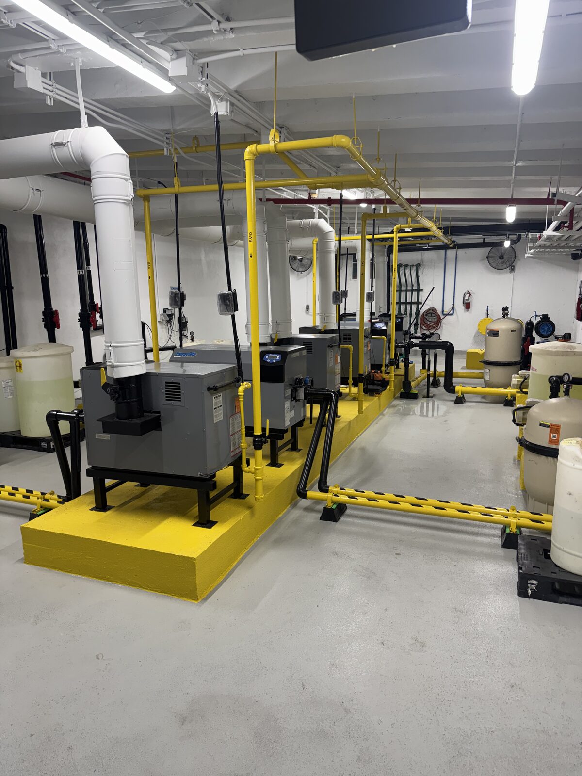 Pump room after renovation with protective bollards and safety striping